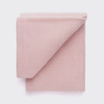 Folded pink baby blanket. 