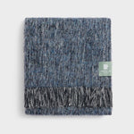 Folded boucle throw in midnight blue fringe.