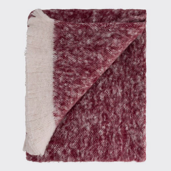 Folded burgundy alpaca throw showing subtle colour and texture variation.