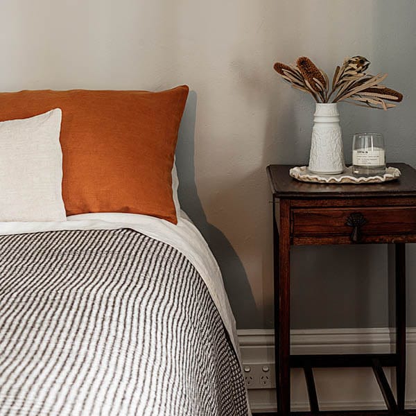 A bed made up with the Frederick waffle blanket.