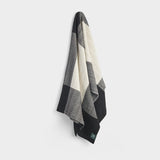 Draped brickfields travel rug in black and natural.