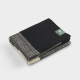 Folded brickfields travel rug in black and natural.