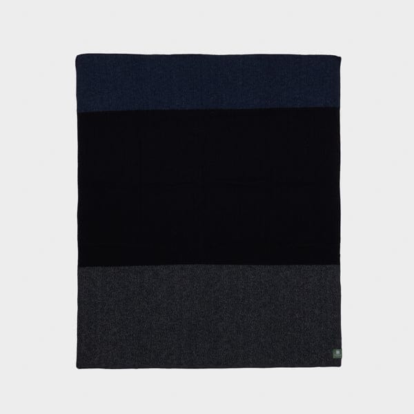 Full view of Nox Tonal throw in black, navy and grey.